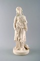 Large Minton biscuit figure of peasant girl with sheaf.
