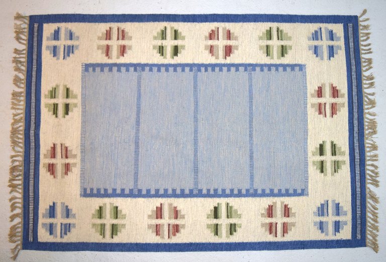 Hand-woven rug / carpet of wool in "rölakan" technique. Geometric fields in 
green, blue and red. 1960