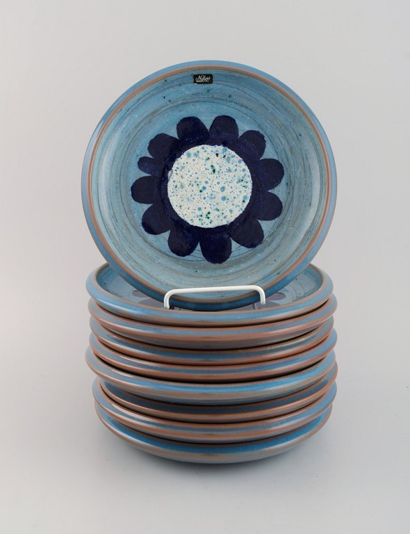 Nittsjö, Sweden. Nine retro plates in glazed stoneware. Beautiful glaze in light 
blue shades. 1960