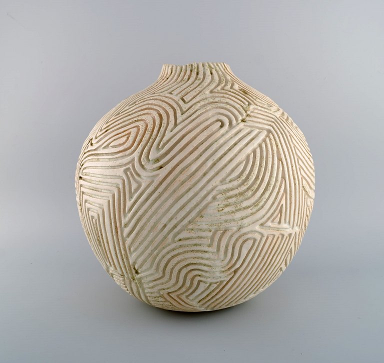 Christina Muff, Danish contemporary ceramicist (b. 1971). Large hand modeled 
sculptural vase made from stoneware clay with figurative carvings and detailed 
with minerals in the creamy white glaze. Part of the ‘Soil