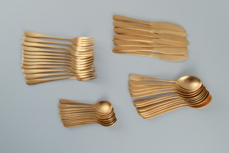 Lagerhaus, Sweden. Dinner service in brushed brass for twelve people. Swedish 
design, 21st Century.
