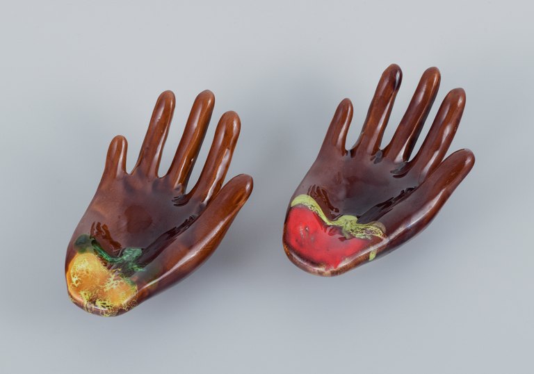 Vallauris, France, a pair of ceramic bowls shaped like hands in brightly colored 
glazes.