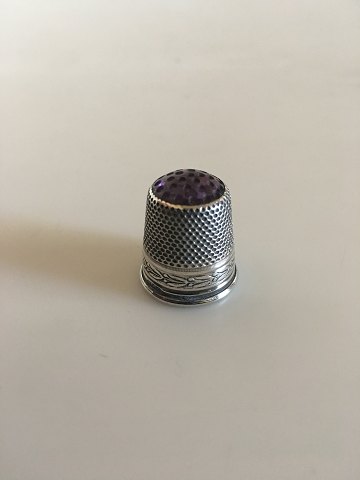 Thimble in Silver with Purple Stone (Amethyst) in the top.