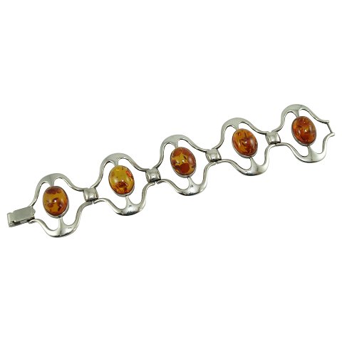 A silver bracelet set with amber