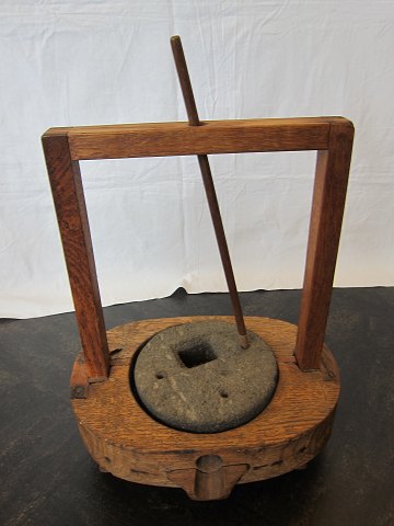 Hand-Mill, mustard-mill, antique, about 1800
This Hand-mill is incl. the stone as well as the stick
By placing the stick into one of the small holes you are able to turn the stone 
around and the liquid will flow out of the spout (please see the photo)