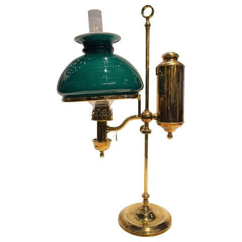 A tablelamp of brass with green glass shade