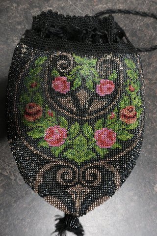 Antique Handmade bag, made of beads
This beautiful old handmade bag, from about the end of the 1800-years, is 
handmade of beads with embroidery which shows roses
The shape is with cords at the top that can tie the bag together and is the 
"handle"