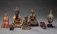 A collection of oriental figures in bronze and wood in form of Buddhas, foo dog 
etc.