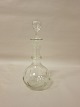 Decanter/carafe, glass with stopper
About 1920
With olive cuttings
H: 22cm incl. stopper
We have a large choice of antique glass, 
decanters as well as jugs