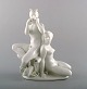 Harald Salomon for Rörstrand, white glazed porcelain Art Deco figure of a naked 
woman and flute-playing pan.