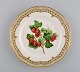 Royal Copenhagen Flora Danica fruit plate in openwork porcelain with 
hand-painted berries and gold decoration. Model number 429/3584. Dated 1963.
