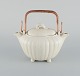 Gunnar Nylund for Rörstrand. Double jug in glazed ceramic. 
Cream colored eggshell glaze and wicker handle.