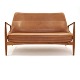 Ib Kofod-Larsen "The Seal" two seater sofa, teak and leather, by Brdr. Petersen, 
Denmark. Nice condition. L: 138cm