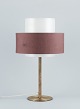 Luxus, Sweden. Large table lamp in brass with a shade in plastic and brown 
fabric.