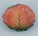 Ipsens, Denmark. Ceramic bowl with wavy rim.
Design depicting plant growth. Glaze in orange and green tones.