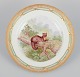 Royal Copenhagen Fauna Danica dinner plate with a motif of a pine marten in a 
landscape.