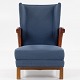 Roxy Klassik 
presents: 
Armchair 
in each 
patinated niger 
leather and 
blue textile 
with brass 
rivets and 
walnut ...