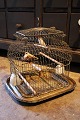K&Co. presents: 
Decorative, 
antique 19th 
century French 
metal birdcage 
on a brass 
tray...