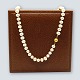 Antik 
Damgaard-
Lauritsen 
presents: 
A pearl 
chain with 14k 
gold clasp, l. 
62 cm.