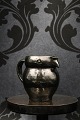 K&Co. presents: 
"Lillerød" 
owl jug in 
glazed 
earthenware in 
fine dark green 
glaze...