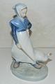Porcelain figure of girl with goose from Royal Copenhagen. In perfect condition. First Sorting. ...