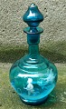 Blue decanter
glass with
enamel
decoration