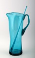 Lemonade
pitcher with
stir stick in
green blue
glass. Lemonade
pitcher with
stir stick in
green blue
glass.
