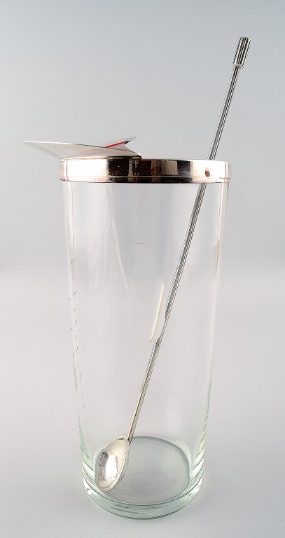 Ole Hagen, b. 1913, d. 1984
Clear glass cocktail pitcher with mounting and stirring spoon of sterling 
silver. Made and stamped by A. Michelsen.