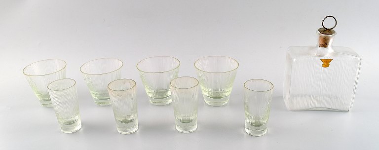 Gullaskruf vodka / schnapps set in art glass. Four plus four vodka / schnapps 
glasses and schnapps decanter  in modern design.