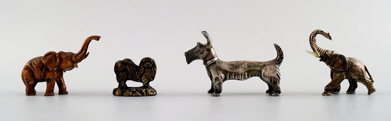 Four miniature figures in various metals, early 1900s.
