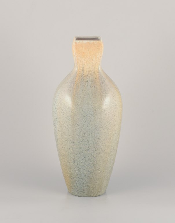 Rörstrand, Sweden. Colossal faience vase. Hand-glazed in green, yellow, and blue 
hues.