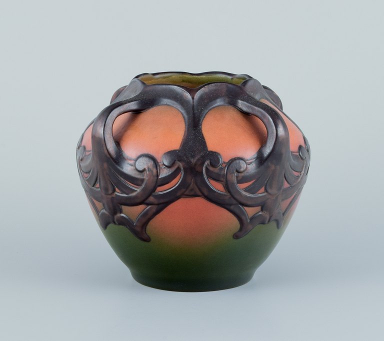 Ipsens, Denmark. Ceramic vase in Art Nouveau style.
Design depicting plant growth. Glaze in orange and green tones.