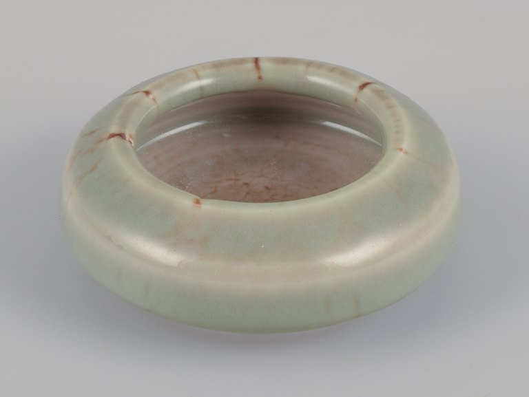 Bengt Ekeblad (1922-2003), Swedish ceramist for Rörstrand.
Unique miniature ceramic bowl with glaze in greenish shades. A rare piece.