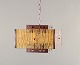 L'Art presents: 
Venhola, 
Finland. 
Ceiling lamp in 
brass and 
amber-colored 
glass.