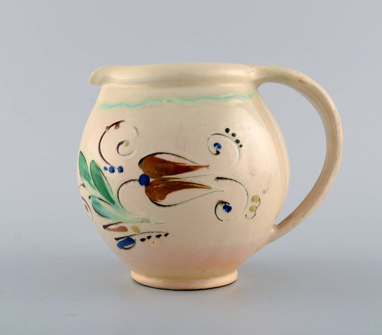Kähler, HAK. Jug in glazed stoneware. Flowers on a cream colored background. 
1930 / 40s.
