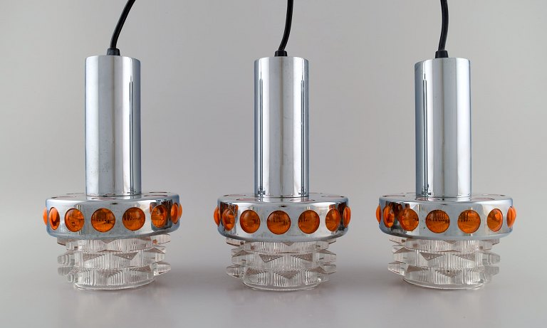 Raak, Holland. Three ceiling pendants in chromed metal and art glass. 1970s.
