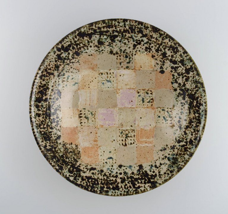 European studio ceramicist. Large unique bowl in glazed stoneware with checkered 
pattern. Dated 1988.

