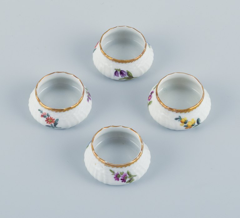Royal Copenhagen, Saxon Flower.
A set of four salt jars, hand painted with flowers and gold edge.