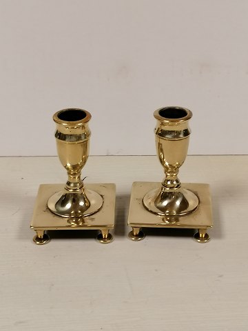 A pair of miniature candlesticks of brass baroque shape