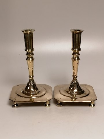 A pair of brass stays on a square base for the 18th century.