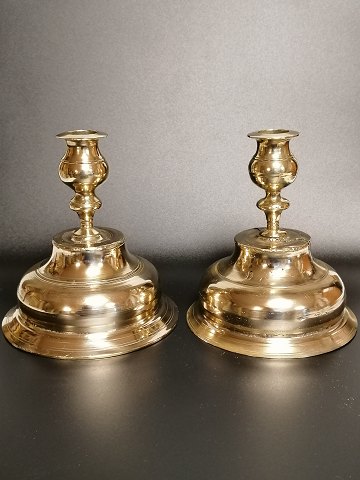 A pair of almost identical brass candlesticks from 
the early 18th century