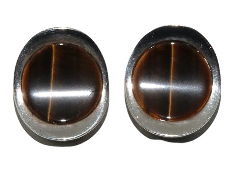 N.E. From silver
Earclips with tigereye stone