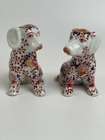 Pair of Japanese Imari porcelain dogs decorated with lotus flowers, vase pattern 
and foliage