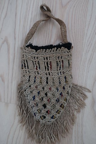 An antique beautiful handbag handmade of flax, and it has the characteristic 
colour of  flax 
The closing is made with a string, handmade as well