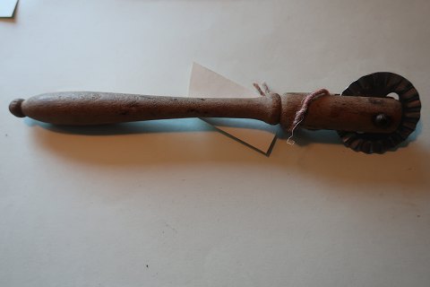 An antique tool for making the danish "klejner" (cakes)
Made of wood with a wheel made of metal