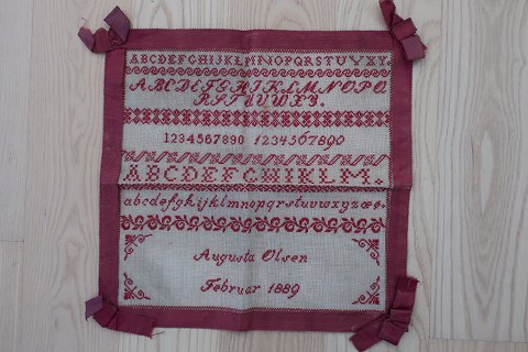 An antique Sampler, handmade red embroider 
With a red band all around as a frame
40cm x 40cm
Dated in the broidery: Februar 1889
In a good condition
We have a large choice of samplers, embroider 
Please contact us for further information