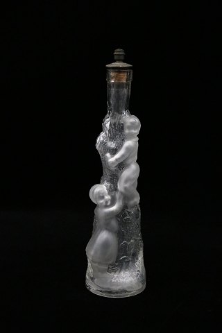 Decorative, old mouth-blown glass carafe with a motif of children climbing up a 
tree trunk...