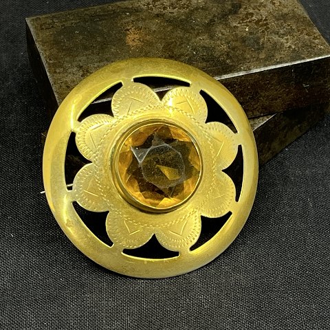 Large gilded brooch with stone