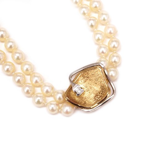 Ole Lynggaard 14kt gold clasp with a diamond of 
0,1ct. Size: 20x20mm