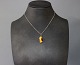 Simpel silverchain with pendant of a piece of amber. 
5000m2 showroom.